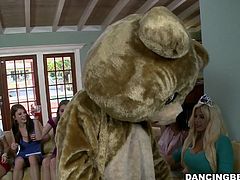 This stripper is dressed in a bear costume. He's wearing nothing but the head of the bear costume while he waves his cock all over the place. They many women at this party take turns sucking his large cock.