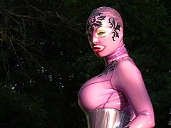 Latex Lucy is one kinky fetish model with huge boobs. Sexy lady in skin tight rubber outfit poses outdoors in the sun and gets her pussy out to masturbate. Watch latex-clad lady rub her twat.