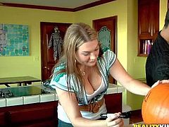 Voodoo and Cassandra Calogera get ready for Halloween together. Naturally busty clothed girl with her hands on pumpkin gets her juicy boobs grabbed by curious guy. He loves her juicy melons.