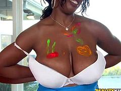Baby Cakes and Delotta are juicy black women with gigantic natural tits. They go topless and then get their massive melons painted by curious white guy. He loves their huge boobies.