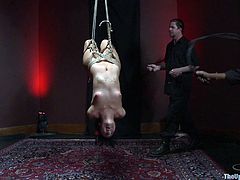 Press play on this bondage scene where a sexy brunette has a great time being tied up and pleased by her two masters.