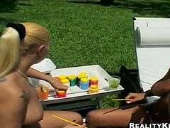 Two Latina hotties are fed up with sunbathing. Already naked and a bit tipsy brunette and blondie have a great idea. They take paint to make some masterpiece on their awesome appetizing boobs.