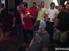 Brunette college guy eating shaft on knees at gay sex party