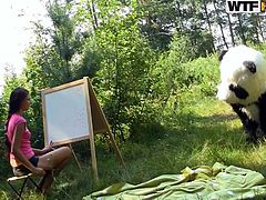 Slutty teen gets nailed by panda bear in outdoor porn session