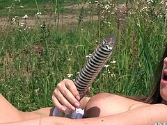 Kinky girl with mind-blowing bust is having fun outdoor. She masturbates using smooth long sex toy. Nicole drives me crazy with her sexuality.