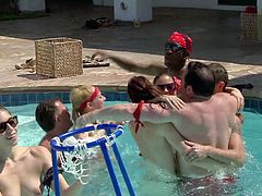 A large gathering of couples are at the mansion for some swinging. Before they switch partners to fuck the all have a giant game of basketball in the swimming area. Some couples get naked in the water and make out.