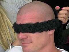 This bald hunk is blindfolded, so he can't see that a guy is touching him. He tries to back off when he realizes, but he doesn't.