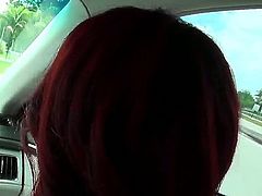 Sexy redhead babe enjoys a hunk guys company and gets naughty in his car in public