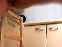 Young naughty blonde Artemis with long legs and nice perky boobs takes off white undies while teasing and starts stuffing shaved wet cunny with vibrator on the floor in kitchen.