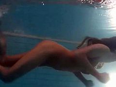 Leggy girl swims and strips naked in pool
