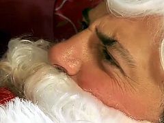 Courtesy of Playboy you can watch a naughty brunette temptress devouring Santa's cock before he pounds her shaved slit into kingdom come.