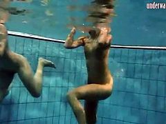 Two bikini beauties get naked in the pool