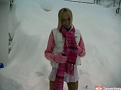 This young blond idiot doesn't think about consequences at all. She heads outdoors in snowy weather wearing a raunchy mini skirt, which she pulls up to poke her vagina with a dildo.
