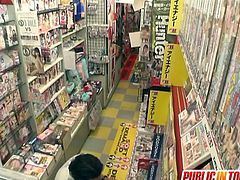 Watch a provocative Japanese brunette belle giving her man a hell of a handjob in the dvd store while he plays with her hairy pussy.
