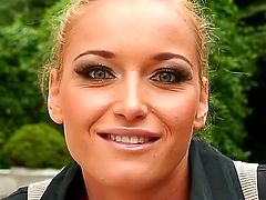 Arousing pretty blonde babe Kathia Nobili with heavy make up and smoking hot body in tight jeans and black shirt gets filmed in close up in backyard and reveals round firm boobs.