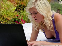This cute blonde girl takes her laptop out onto the porch and goes to her favorite porn site. She finds a video that makes her really wet and then she starts masturbating outside. She doesn't care if the neighbors see her.