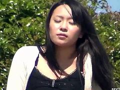 Hot asian babe is all alone on the bench at the park and shows off her big titties then spreads legs and rubs herself for a public orgasm!