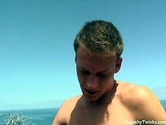 Two hot twinks are turned on when they kiss near the ocean. They touch each other and one bends to suck off his boyfriend's stiff cock!