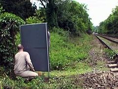 This couple was fooling around by the railway. A voyeur saw them and joined them. She rode her boyfriend and the voyeur came on her tits.