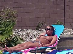The girl knows how to relax as she decides to take a sun bath. Spoiled nymph with big yummy tits feels a bit horny and starts teasing her pussy fervently. Make sure you don't miss her solo scene.