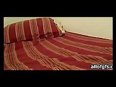 Spreading her legs lying on bed masturbating