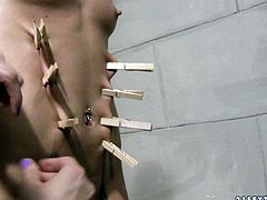 Flat breasted blond fairy gets suspended with her mouth plugged by a rapacious domina before she folds her eyes and starts pinching her naked body with clothing pegs in BDSM-involved sex video by 21 Sextury.