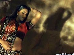 Watch a sexy and exotic bollywood brunette flaunting her lovely body while stripping off in this naughty softcore video.