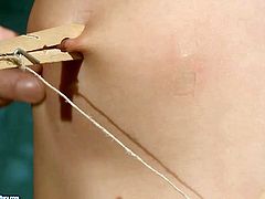 This cruel bondage master knows how to make punishment more effective! He clamps clothespins on her slave's tits, nipples and tongue.