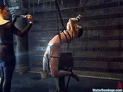 Nasty girl gets tied up by her mistress. After that she gets her body covered with hot wax. She also gets tortured with water.