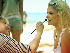 Stunning blonde Playboy model prepares for the photo shoot with a makeup artist. After that she strips her clothes off and shows her hot boobs outdoors.