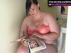 Slutty bitch with insane sex lust is sitting on a toilet tub looking at explicit XXX pictures. She get horny as fuck so she starts rubbing her pussy intensively.