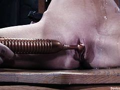 Kinky blonde girl takes her clothes off and gets chained. After that she also gets her mouth gagged and pussy stuffed with big dildo.