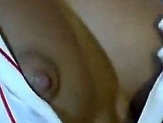 Amazing brunette girl in a uniform shows her titties to some dude in a bedroom. Then she takes his dick out of his pants and gives him a handjob.