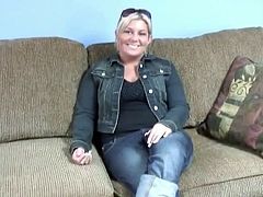 Chubby blonde mom with saggy natural tits is sitting naked on a couch. She slips her hands down caressing her slick pussy.