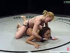 Latin girl loses a fight to White chick. After that Annie gets her sweaty pussy toyed with a strap-on right in a ring.