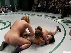 Three bitches in bikini wrestle in the ring and then one of these girls sucks a strap-on. After that she gets her pussy fingered and toyed.