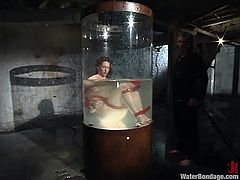 After cleaning her filthy pussy with a water jet and making her feel good, the executor inserts this whore in a cylindrical water tank. The water level raises and so does her anxiety! Let's keep this bitch some company and find out, if she can breath underwater!