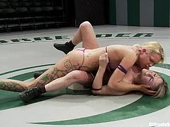 Rain DeGrey and Jessie Cox wrestle in a ring. Then they have wild lesbian sex. The losing girls gets her vagina destroyed with a strap-on.