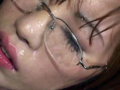 Asian sweetheart receives a large load splashing her glasses after sucking cock like crazy