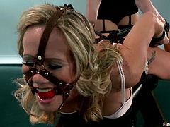 Horny blonde girl gets tied up and gagged by hot brunette. Later on this blondie gets her vagina drilled with electro dildo.