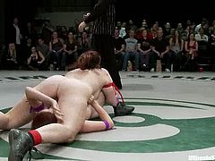 Two passionate redhead chicks wrestle in a ring in public. Then the losing girl gets her vagina fingered hard and deep.