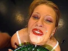 Hottie starts to swallow after having her face covered in jizz during bukkake porn
