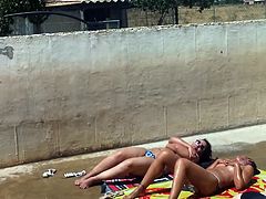 Three caught topless sunbathing