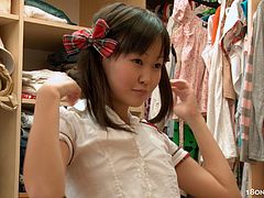 While trying on some clothes this sexy Asian babe slipped into some thigh high stockings and a schoolgirl uniform before toying her tight twat.