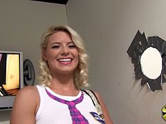 Behind the scenes at a gloryhole shoot, Annika Albrite flashes her panties, shows her perky tits, and touches her tender clit.