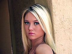 Click to watch this blonde babe, with giant gazongas wearing a cute dress, while she moves erotically around her house and plays with your mind.