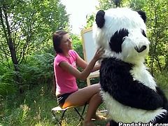 Weird sex in the woods with a huge toy panda with strap on