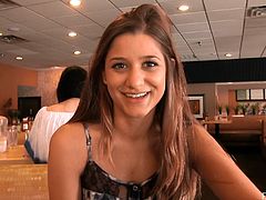 A brown-haired girl with a pretty face talks to some guy in a cafe while drinking coffee. After some time she just lifts her dress up to show the pussy.