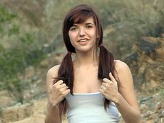 Pretty Alaura jogs in the mountains. This teen girl with pigtails also flashes her nice booty and titties.
