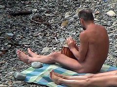 Voyeur feeds his lust by watching nude girls enjoying the sun